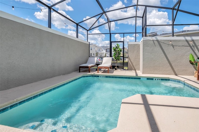 view of pool featuring a lanai and a patio