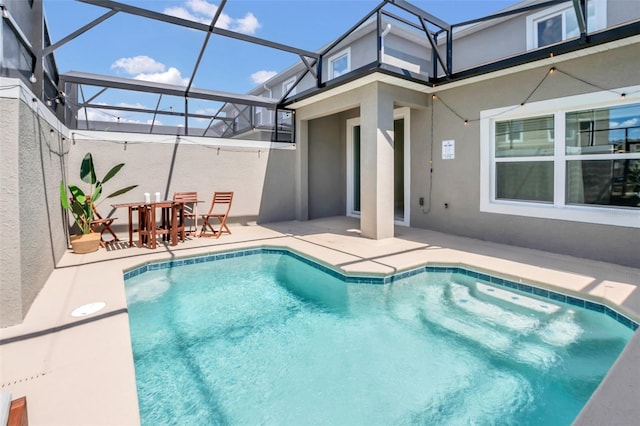 view of pool with a lanai and a patio