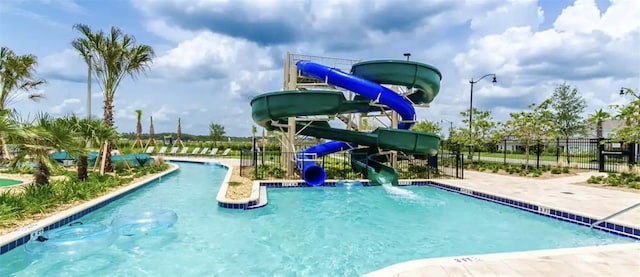 view of swimming pool with a water slide