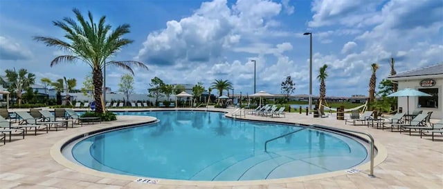 view of swimming pool with a patio