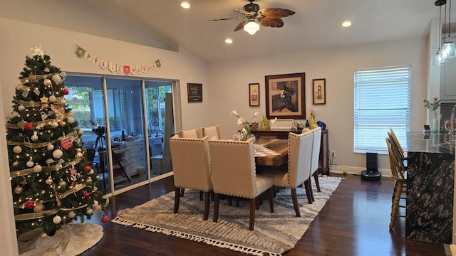 dining space featuring dark wood-type flooring, ceiling fan, and vaulted ceiling