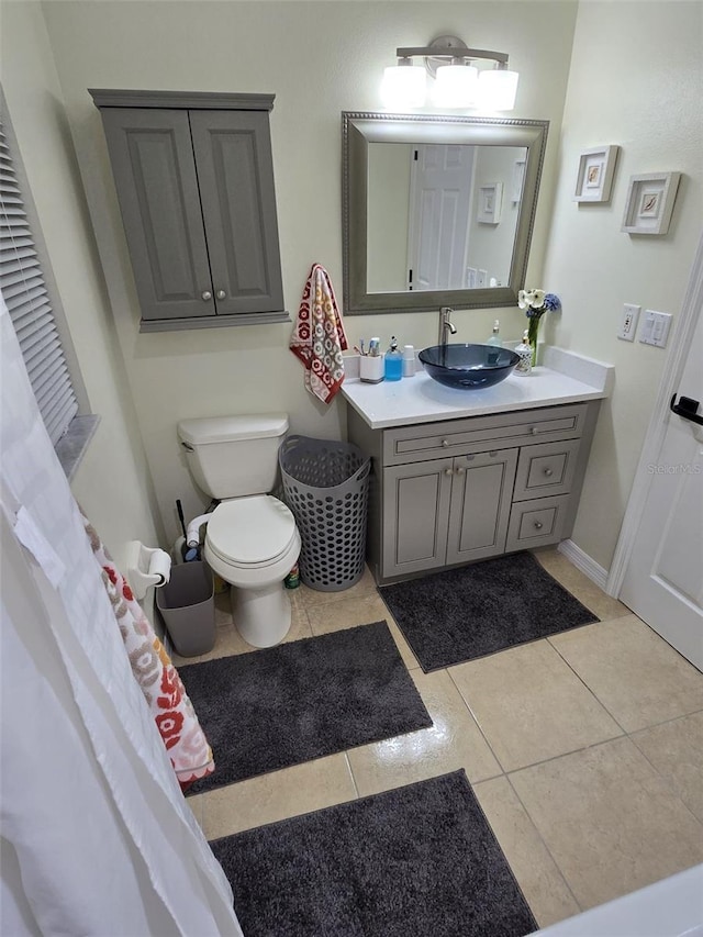 bathroom with vanity, tile patterned floors, and toilet