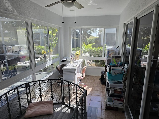 sunroom / solarium featuring ceiling fan