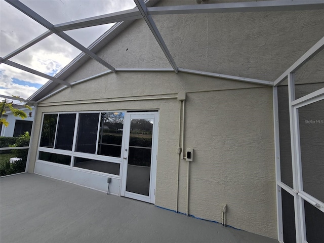 unfurnished sunroom with vaulted ceiling