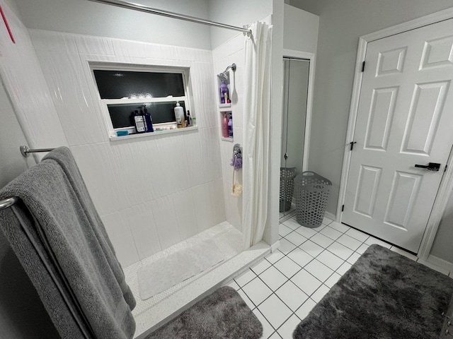 bathroom with a shower with curtain and tile patterned floors