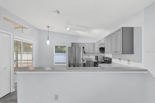 kitchen with visible vents, gray cabinets, appliances with stainless steel finishes, light countertops, and vaulted ceiling