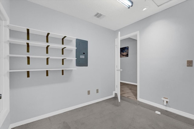 empty room with electric panel, visible vents, and baseboards