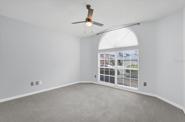 unfurnished room with baseboards, carpet floors, lofted ceiling, ceiling fan, and a textured ceiling