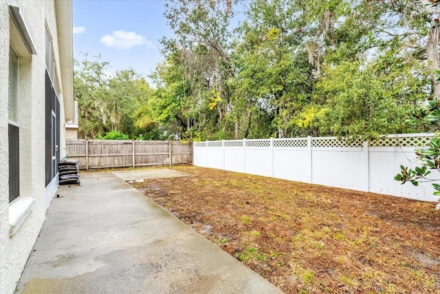 view of yard with a patio area and a fenced backyard