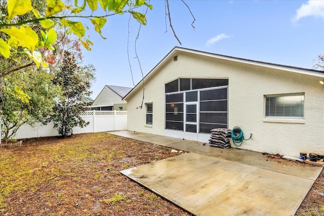 back of property featuring a patio area, stucco siding, and fence