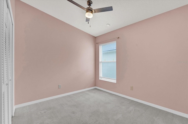 unfurnished room with baseboards, light colored carpet, and ceiling fan