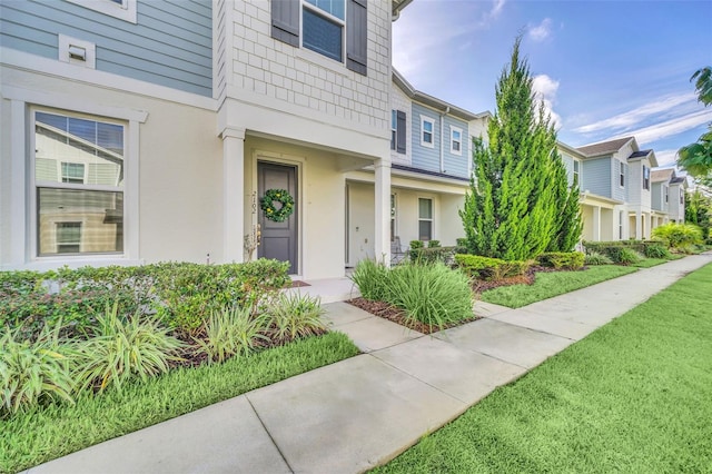 doorway to property with a lawn