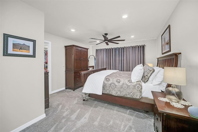 bedroom with ceiling fan and light colored carpet