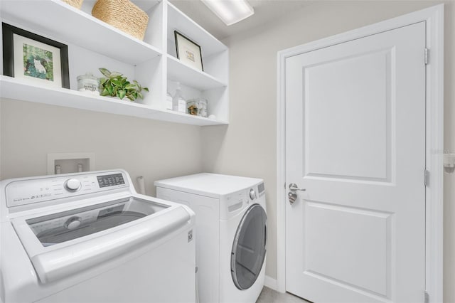 clothes washing area featuring independent washer and dryer