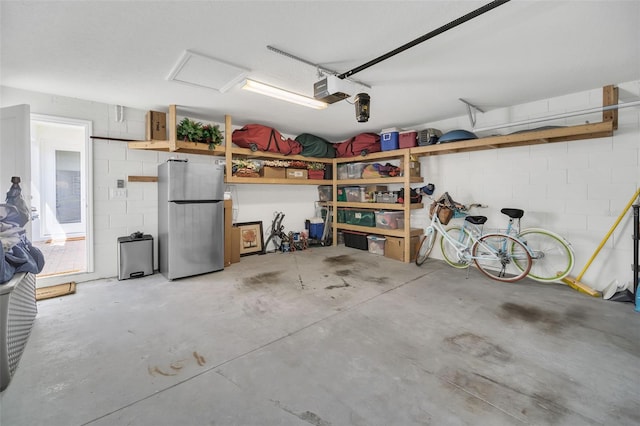 garage with stainless steel refrigerator