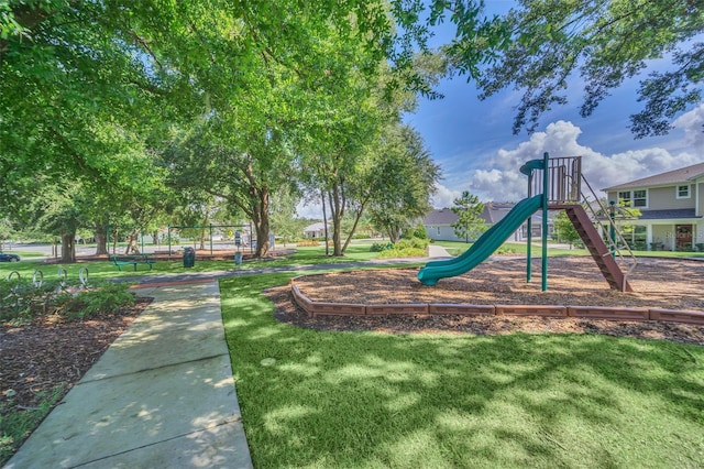 view of playground with a lawn