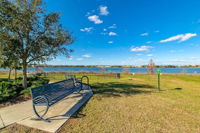 view of property's community with a yard and a water view