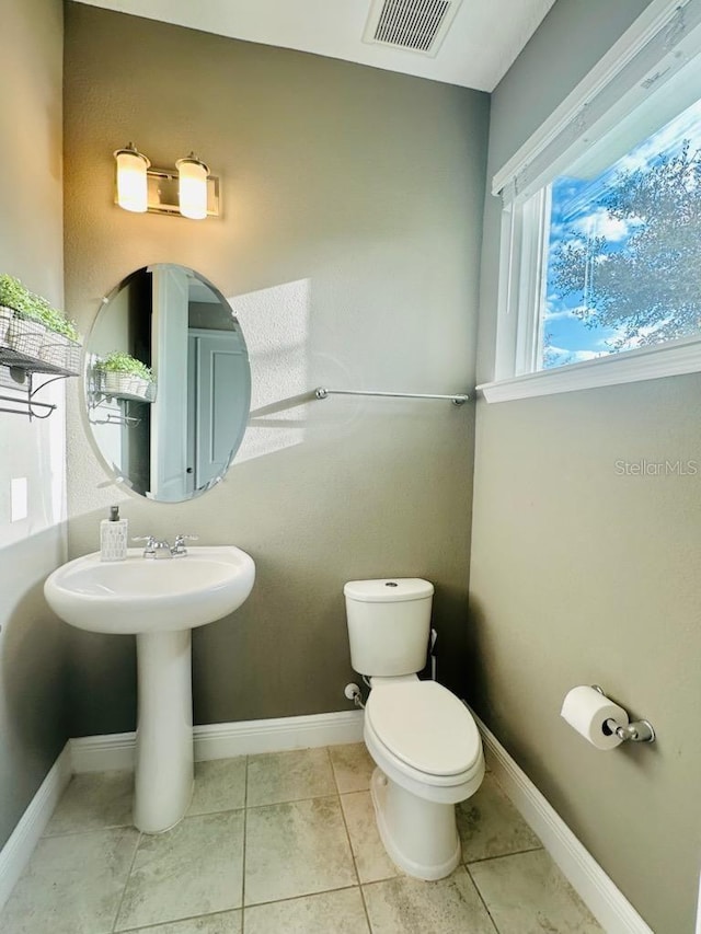 bathroom featuring tile patterned floors and toilet