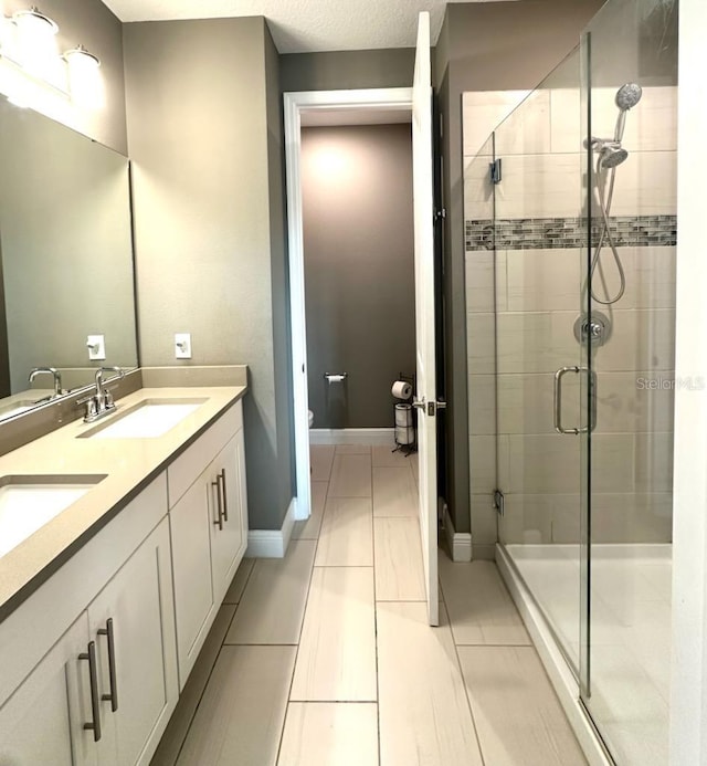 bathroom with vanity, tile patterned floors, and a shower with shower door