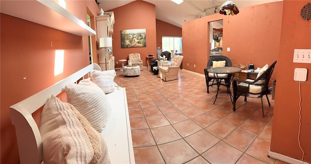 living room with vaulted ceiling and light tile patterned floors