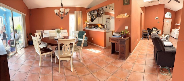 tiled dining space with an inviting chandelier, lofted ceiling, and plenty of natural light