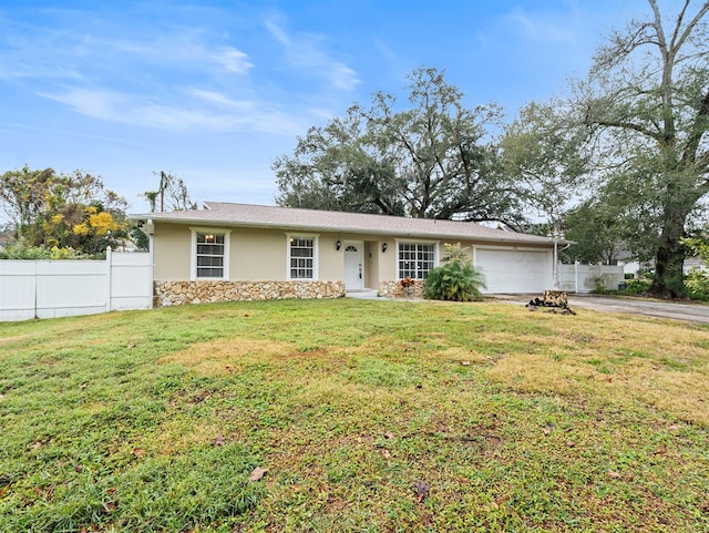 ranch-style home featuring a garage and a front yard