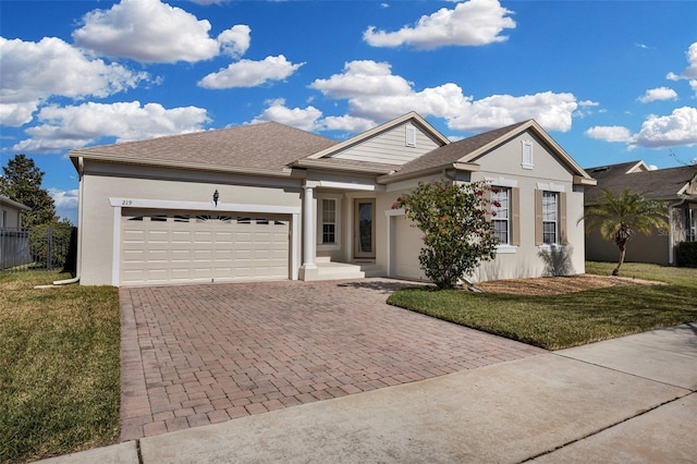 view of front of home with a garage and a front yard