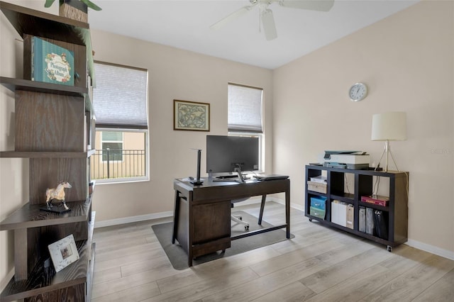 home office with ceiling fan and light hardwood / wood-style floors