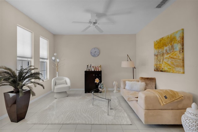 tiled living room featuring ceiling fan