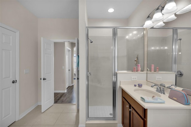 bathroom featuring walk in shower, tile patterned floors, and vanity