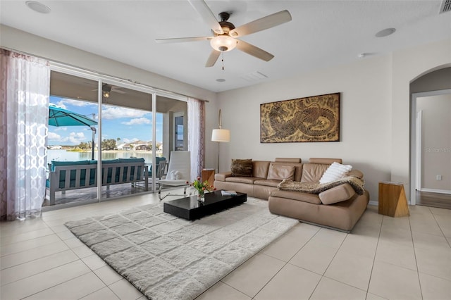 tiled living room featuring ceiling fan