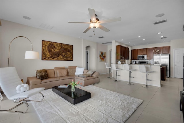 tiled living room featuring ceiling fan