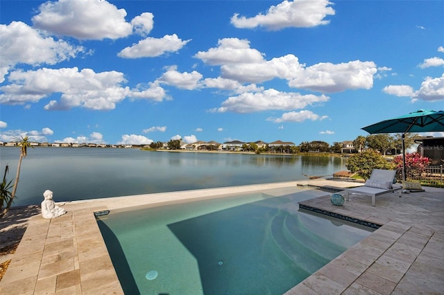 view of swimming pool featuring a water view and a patio area