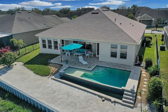 back of house featuring a fenced in pool and a patio area