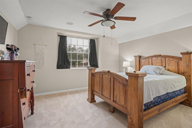 bedroom featuring lofted ceiling, ceiling fan, light carpet, and baseboards