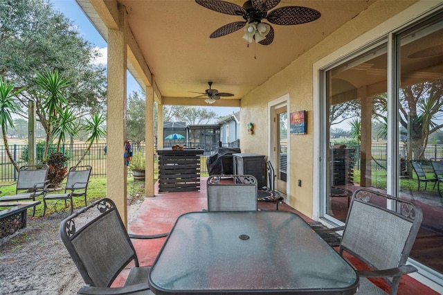 view of patio / terrace featuring outdoor dining area, grilling area, fence, and a ceiling fan