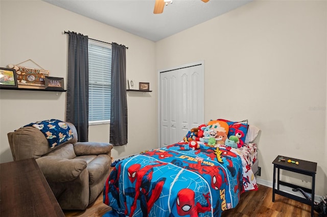 bedroom with baseboards, a closet, a ceiling fan, and wood finished floors