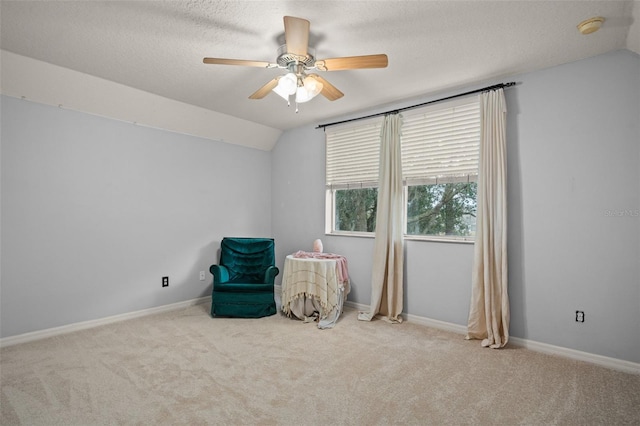 unfurnished room with lofted ceiling, a textured ceiling, and carpet