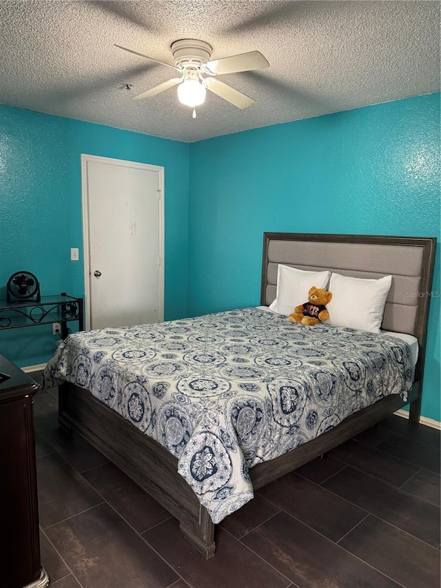 bedroom with a textured ceiling and ceiling fan