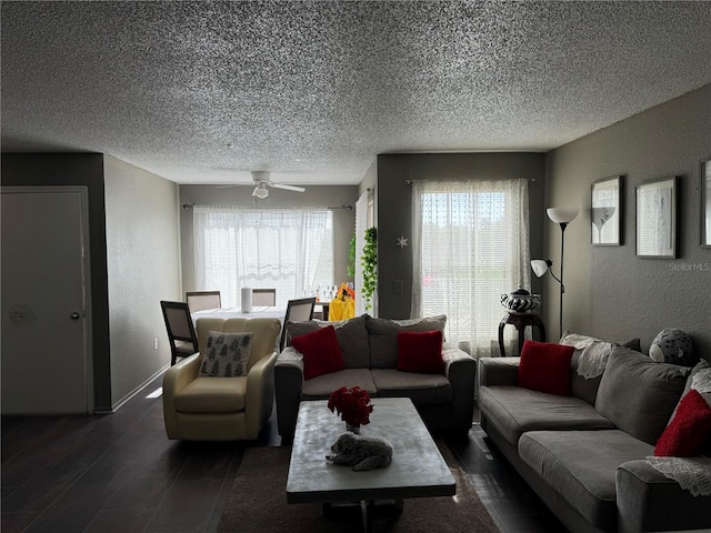 living room featuring ceiling fan and a textured ceiling