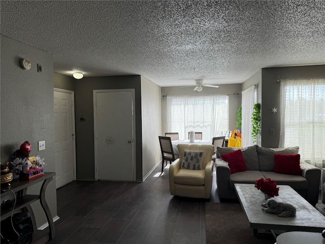 living room featuring a healthy amount of sunlight, a textured ceiling, and ceiling fan