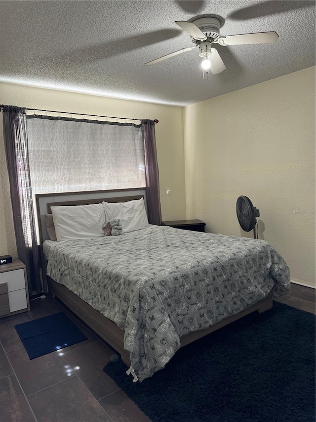 bedroom featuring a textured ceiling and ceiling fan