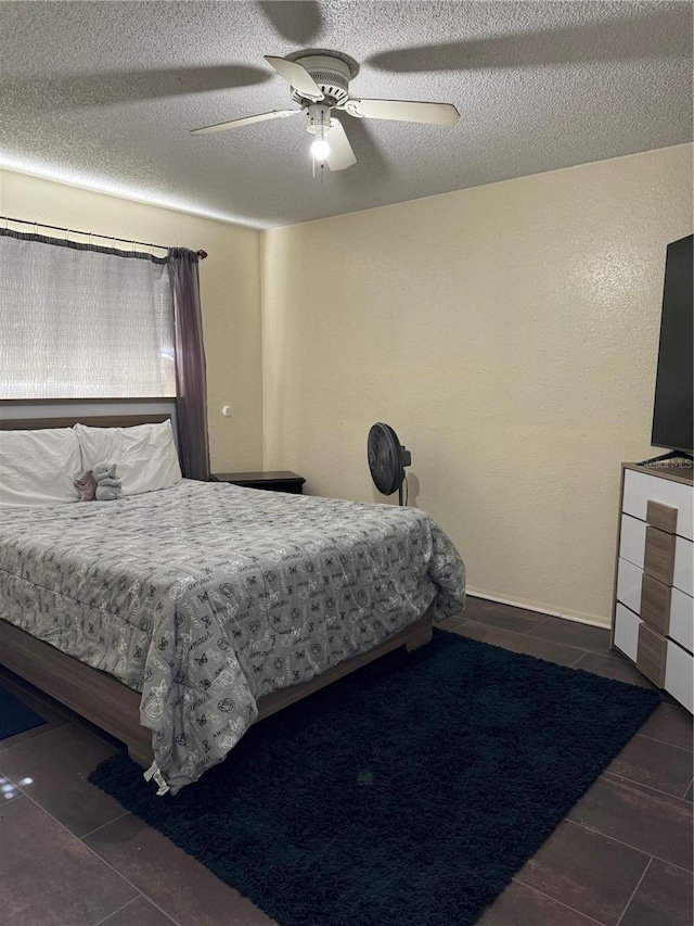 bedroom featuring a textured ceiling and ceiling fan