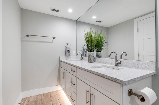 bathroom with hardwood / wood-style flooring and vanity