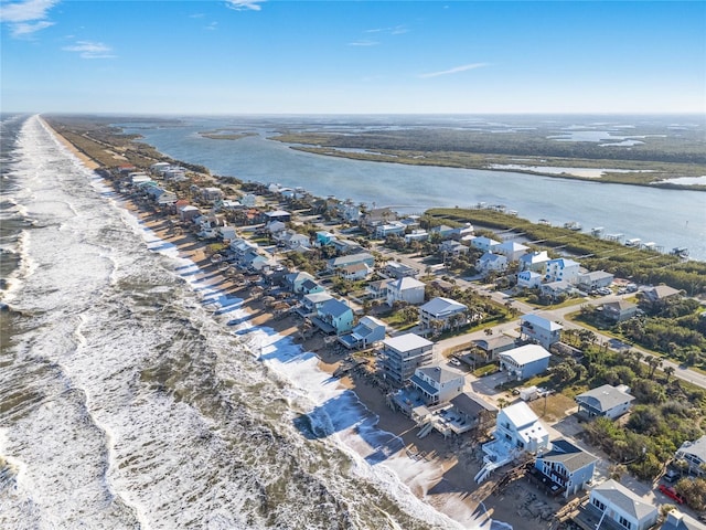 aerial view with a water view and a beach view