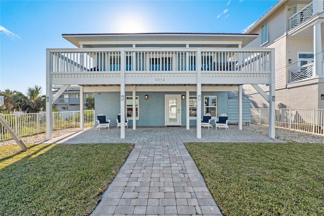rear view of house featuring a yard, a fenced backyard, and a patio area