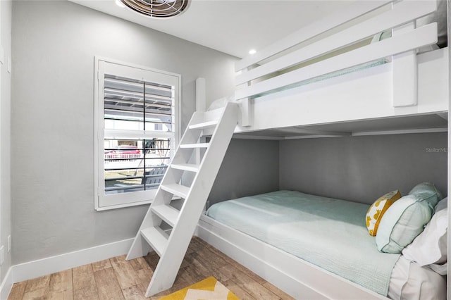 bedroom featuring baseboards and wood finished floors