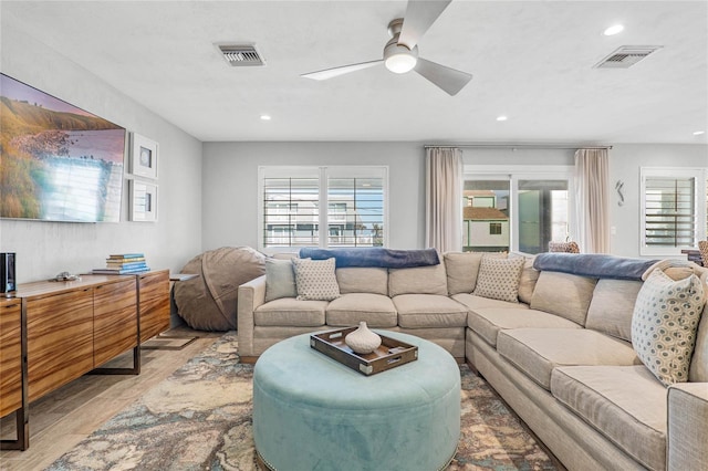 living area featuring visible vents, recessed lighting, light wood-style flooring, and ceiling fan
