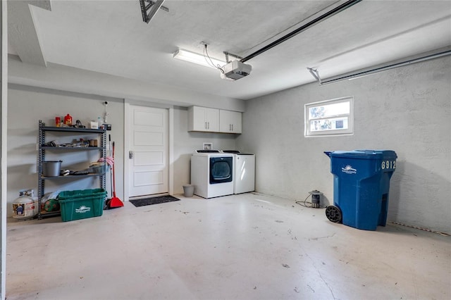 garage featuring separate washer and dryer and a garage door opener