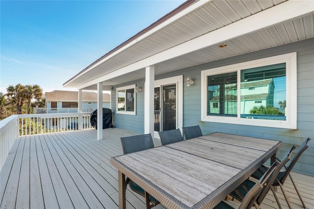 wooden terrace with outdoor dining area